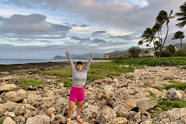 Sam Claridge happy and standing on rocks.